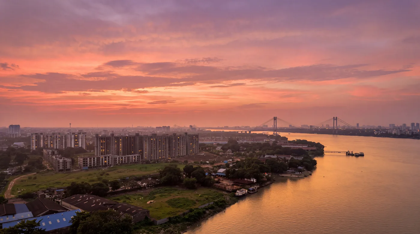 The Shalimar riverbank and Vidyasagar Setu at golden hour, photographed over the district